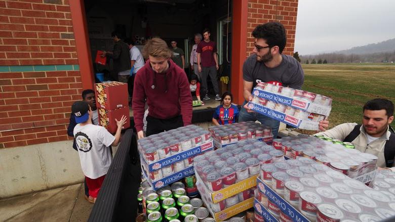 students unloading food donations off truck